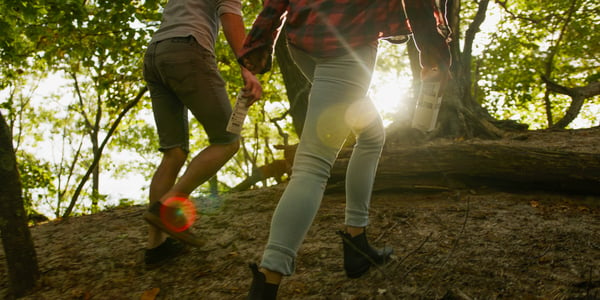 two people hiking in forest 